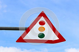 Sign Attention traffic light over blue sky