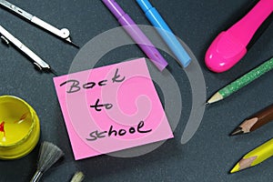 Sign ,,Back to school` on sticker and school aid.