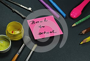 Sign ,,Back to school` on sticker and school aid.