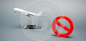 The sign of the ban and a miniature toy aircraft. Ban on flights of civil aircraft. Forbidden zone. Stop symbol. Bans on airport