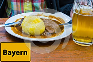 Sign Bavaria german `Bayern` in Front of Beer and Roast Pork with Dumplings