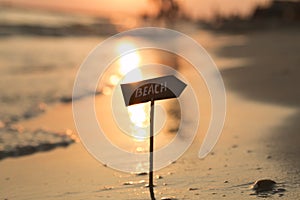 Sign beach, sunset at sea, blurred photo for background