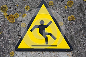 Sign beware slippery floor on a wall