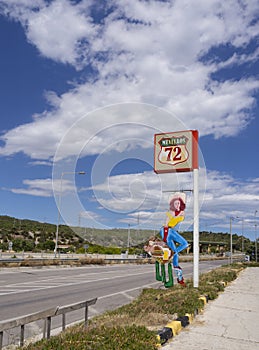 Greece, June 2020:  Sign of a biker bar in Greece on the autobahn with the image of a girl with a suitcase in the cowboy style