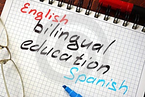 Sign bilingual education written in a notepad photo
