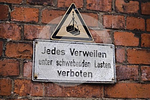 a sign on a brick wall stating Every staying forbade, Jedes Verweilen verboten