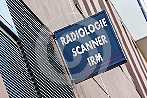 Sign on building indicating radiology MRI and medical scan services (Radiologie Scanner IRM in French)