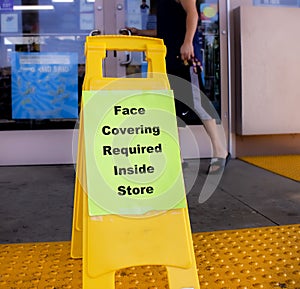 Sign at a business stating faces masks are required photo