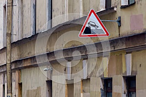 Sign of a car falling off a cliff into the water