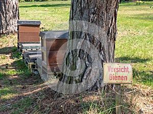 Sign caution bees in the park in german