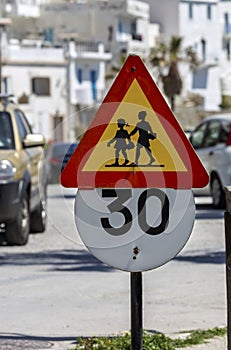 Sign `Caution children` and sign `Speed limit` close-up.