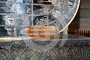 Sign cautioning tourists of pickpockets at Wat Pho in Thailand English translation - Beware Pickpockets