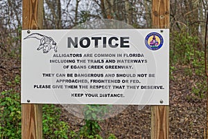 Sign cautions visitors to respect and keep a distance from alligators