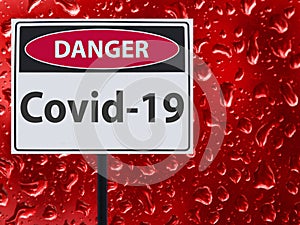 Sign Covid-19 and red blood drop on the glass.