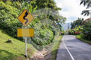 Sign curved road on the way at the natural Field Or forest. Warning attention Right curve sign at Rural highway. Road sign showing