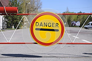 Sign Danger on a barrier, crossing point Dytiatky where Chornobyl Exclusion Zone begins.