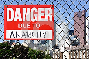 Sign danger due to anarchy hanging on the fence