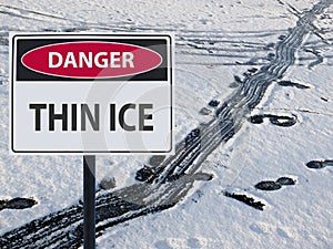 Sign danger thin ice and footprints on snow and ice