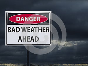 Sign dangerous bad weather ahed and dark clouds of snow and rain