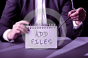 Sign displaying Add Files. Word for To put more information to a certain person,thing,or document -47872