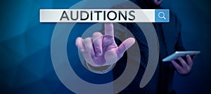Sign displaying Auditions. Concept meaning a trial performance to appraise an entertainer's merits photo