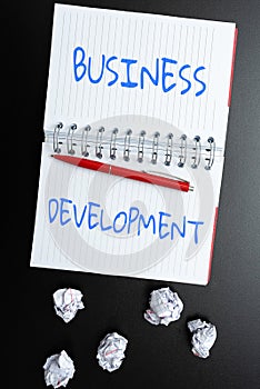 Sign displaying Business Development. Business overview Implement Growth Value within and between company Thinking New