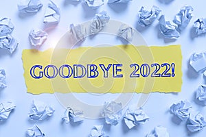 Sign displaying Goodbye 2022. Internet Concept New Year Eve Milestone Last Month Celebration Transition Crumpled Notes photo