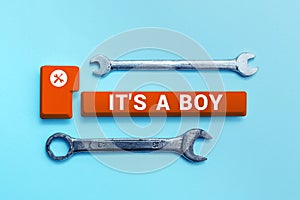 Sign displaying It's A Boy. Word Written on Expecting a male baby cute blue colors a lot of car toys