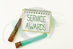 Sign displaying Service Awards. Word for Recognizing an employee for his or her longevity or tenure Preparing And