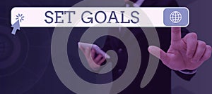 Sign displaying Set Goals. Business approach Defining or achieving something in the future based on plan Businessman in