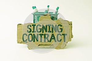 Sign displaying Signing Contract. Business concept the parties signing the document agree to the terms Tidy Workspace