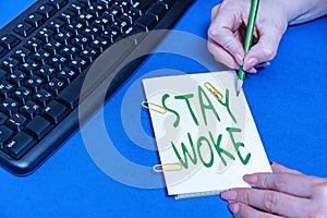 Sign displaying Stay Woke. Business showcase being aware of your surroundings and things going on Keep informed Hands