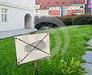 Sign: don`t walk on the grass. Prohibitions in our lives