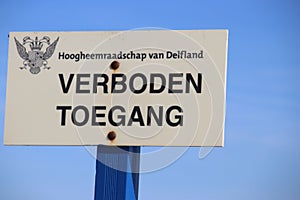 Sign with dutch text Verboden toegang which means in English no admittance of the water authority Delfland in the dunes of Monster