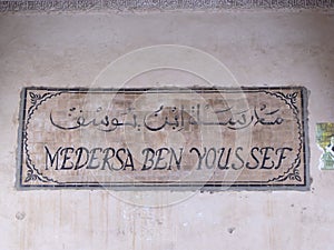 Sign at the entrance of the Ben Youssef Medersa in Marrakech. Morocco