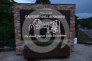 Sign at the entrance of the town with the text CastaÃÂ±o del Robledo where all the roads start from photo