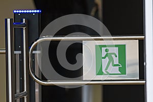 Sign - exit, green emergency exit on turnstile