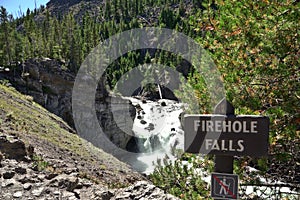 Sign of Firehole Falls with the river on the background in Yellowstone National Park, USA