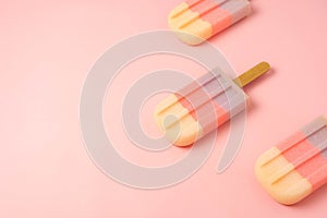 Sign or food of summer season holiday background concept.Lay of sweet pastel ice cream on modern rustic pink paper backdrop.