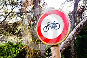 Sign forbidden to ride a bicycle, placed in a forest