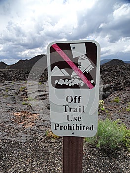 A sign forbidding hiking off the trail