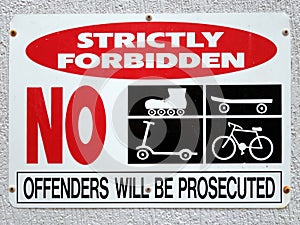 A sign forbidding the use of cycles, scooters, skateboards and roller skates