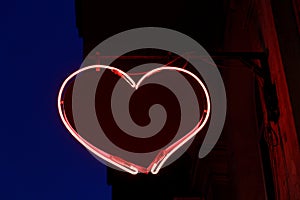 Sign in the form of red heart from neon