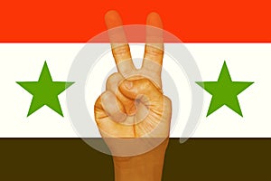 Sign of freedom on the fingers. The Syrian flag.