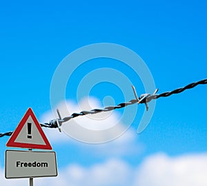 Sign Freedom in Front of barbed wire