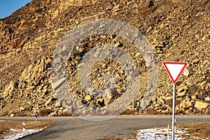 Sign give way on mountain road