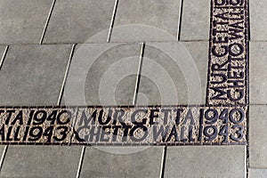 Sign on the ground marking where the ghetto wall was in Warsaw in World War II