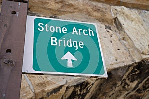Sign guiding visitors directions to the iconic Stone Arch Bridge in downtown Minneapolis