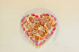 Sign heart lined with peeled pistachios, walnuts and almonds.