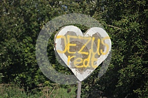 Sign in heart shape with text Jezus redt in Dutch Language which means Jesus saves